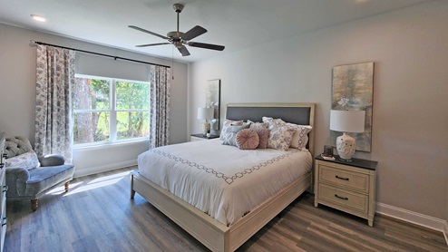 The Dover primary bedroom with large windows.