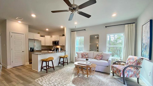Open concept living area with kitchen in the distance.