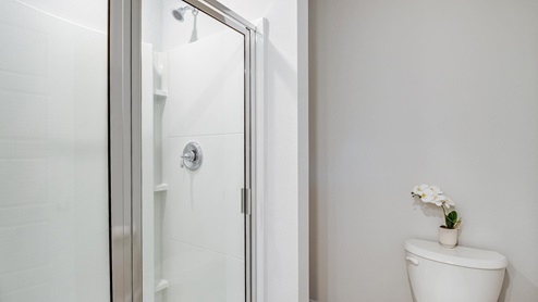 Primary Bathroom with standing shower and commode.