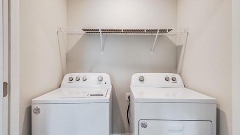 Upstairs laundry area in large hall closet.