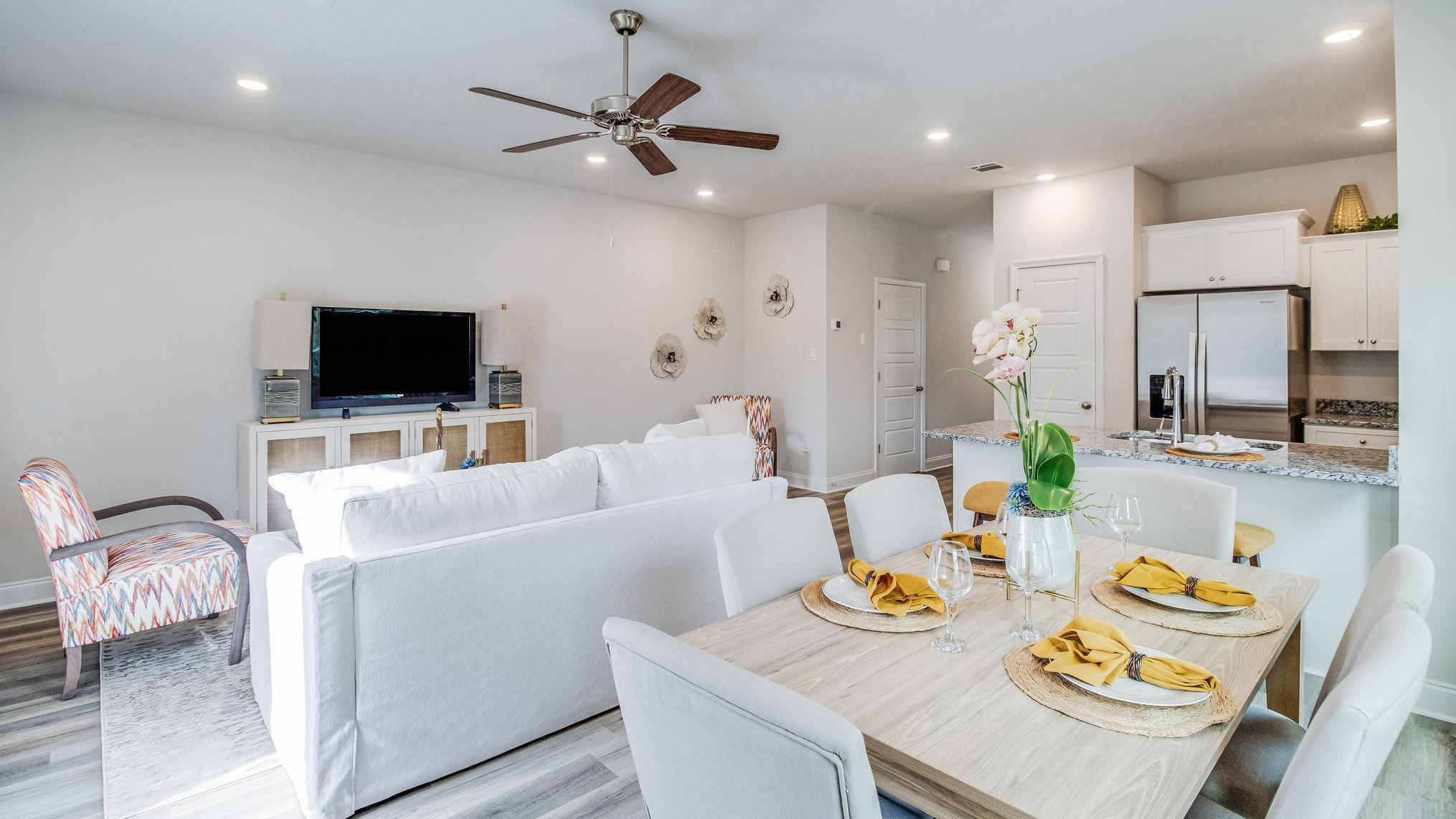 Open concept dining area with simple furnishings connecting to the living area.
