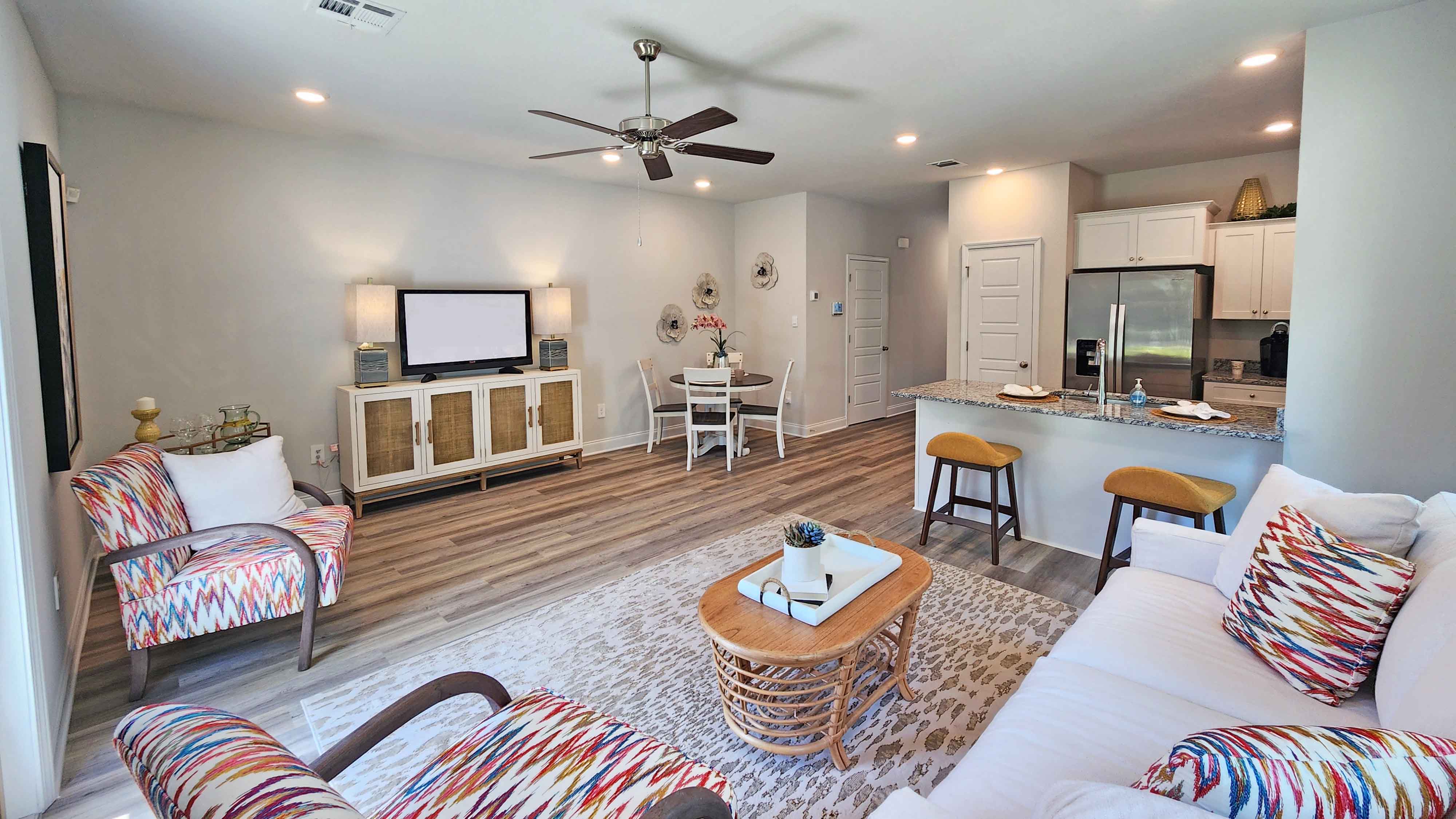 Living area with simple furnishings and an area rug.