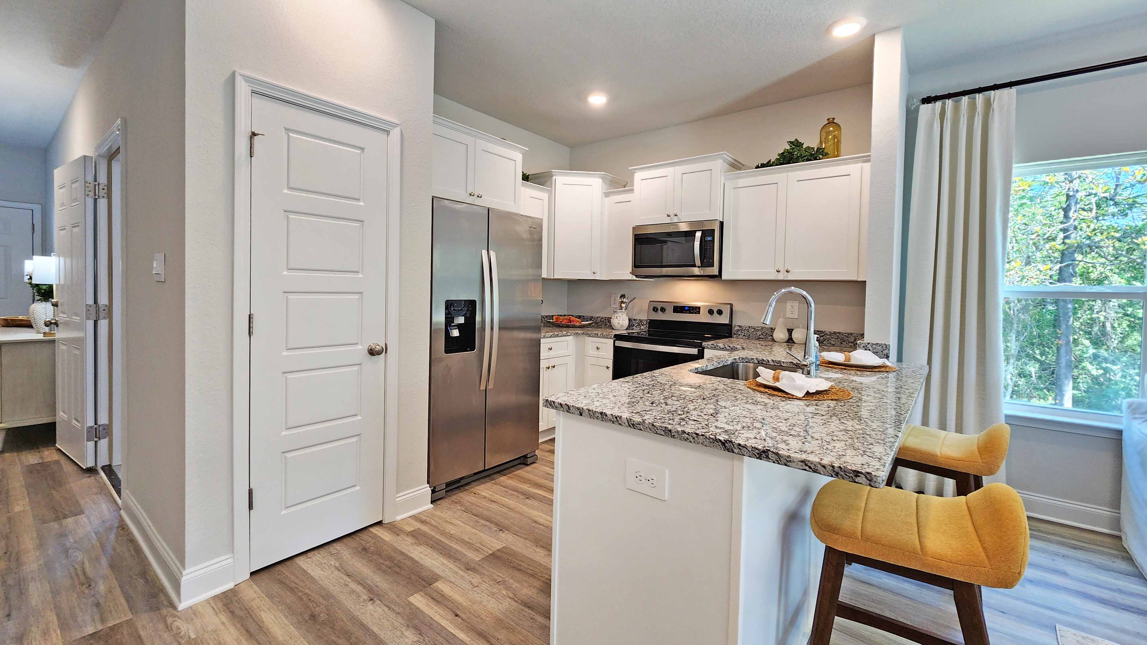 Kitchen featuring cabinets, new stainless steel appliances, and a large standing island.