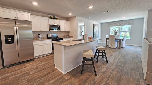 Aria kitchen with white shaker-style cabinetry and island.