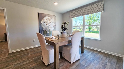 Breakfast area with windows and patio door with access to covered porch.