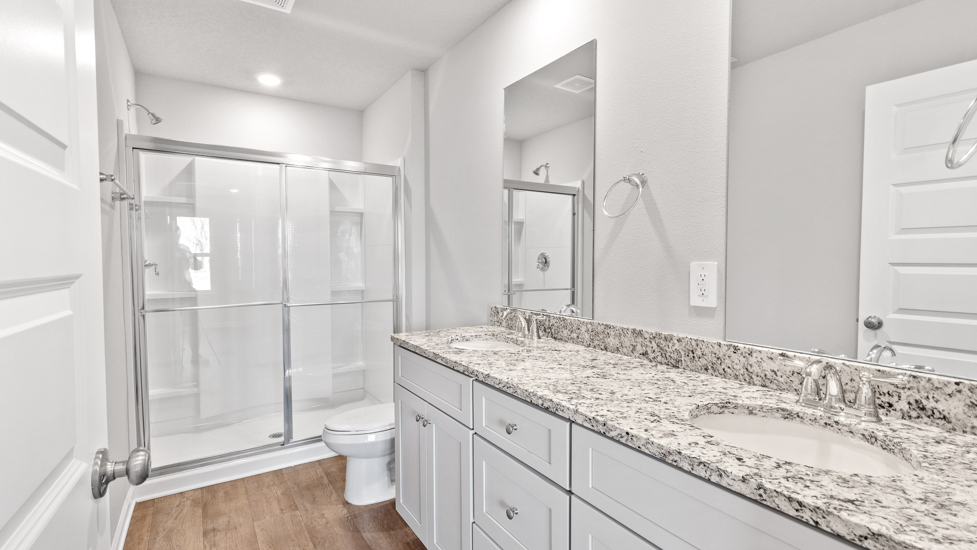 Sleek and luxurious primary bathroom suite