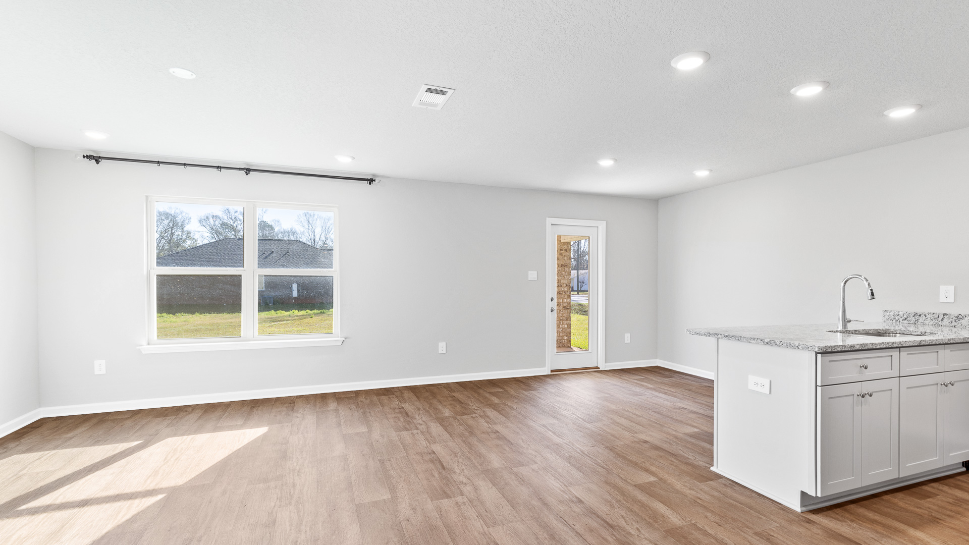 Spacious and bright living area connected to kitchen