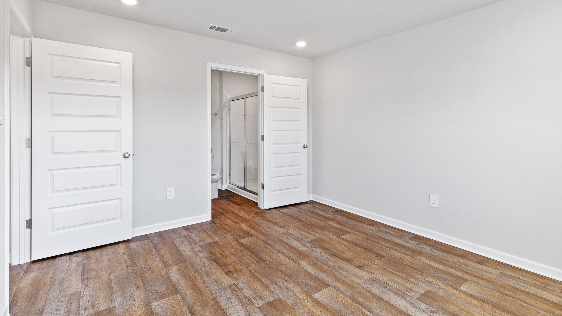 Bright and airy primary bedroom inside the Freeport
