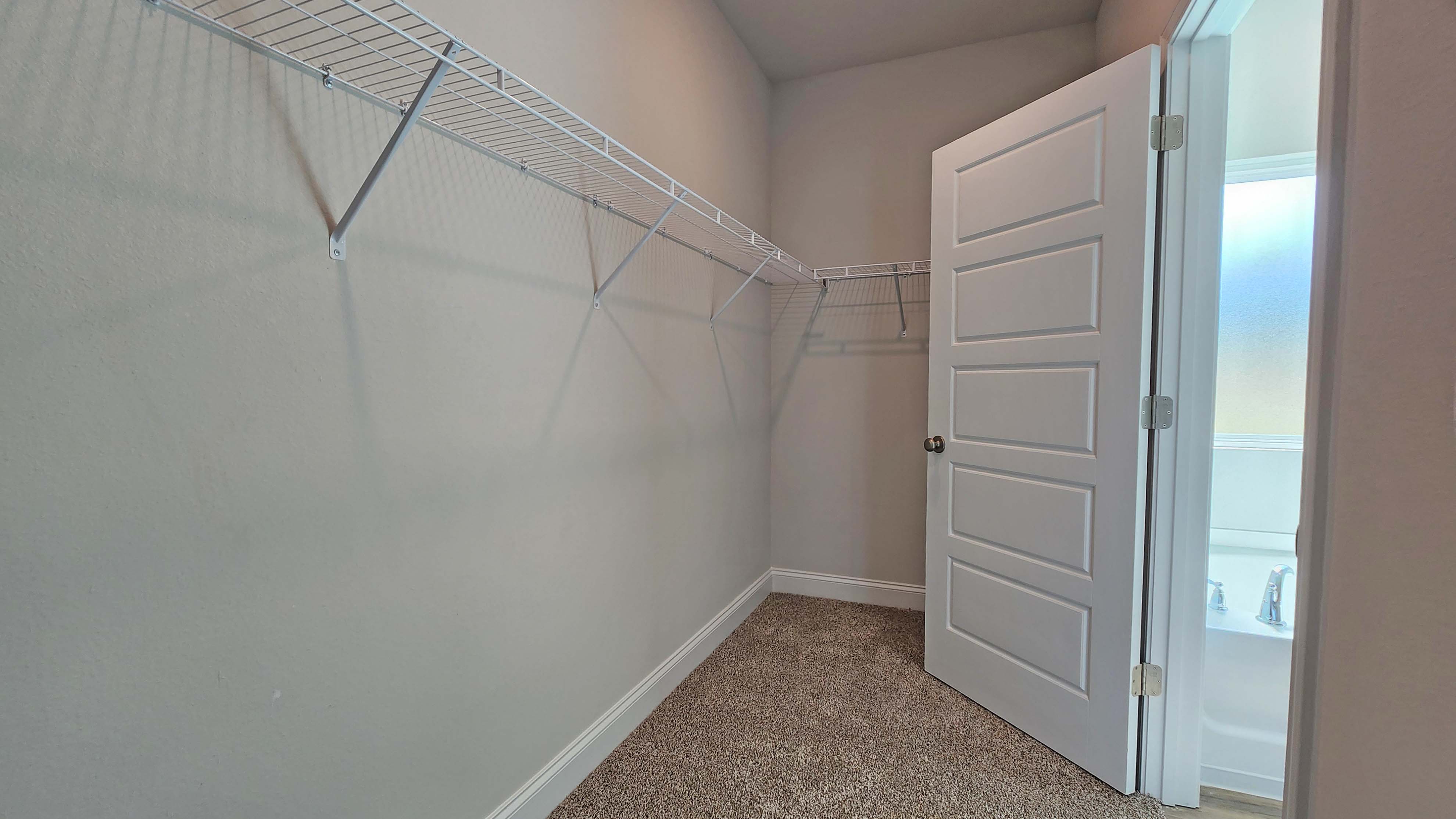 The Destin primary walk in closet in Crane Landing.