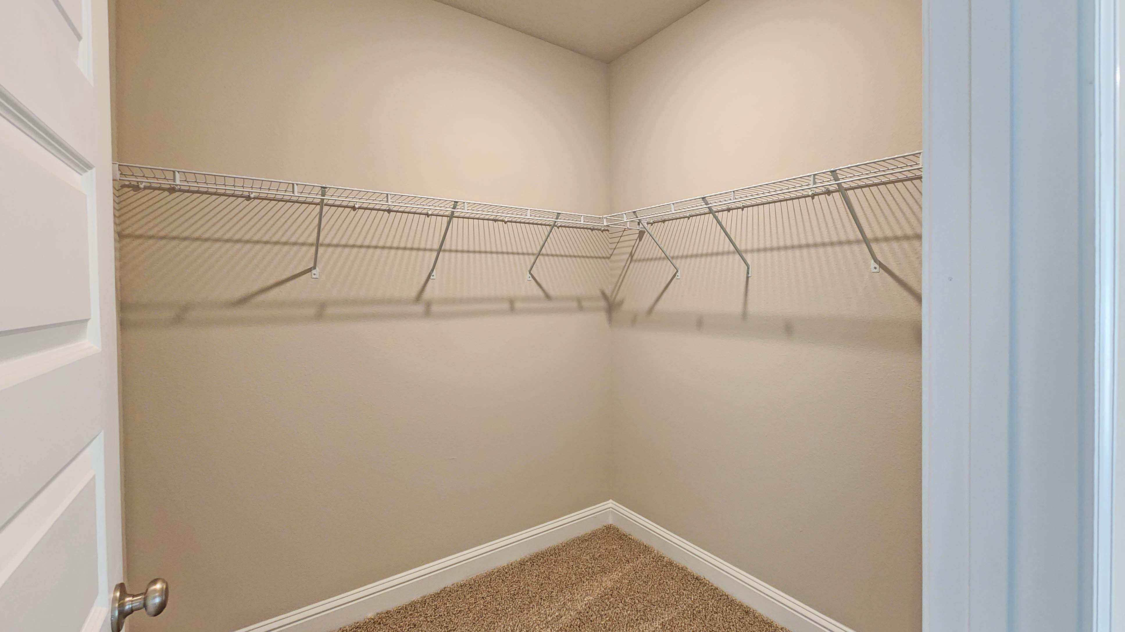 The Hawthorne primary walk-in closet at Crane Landing.