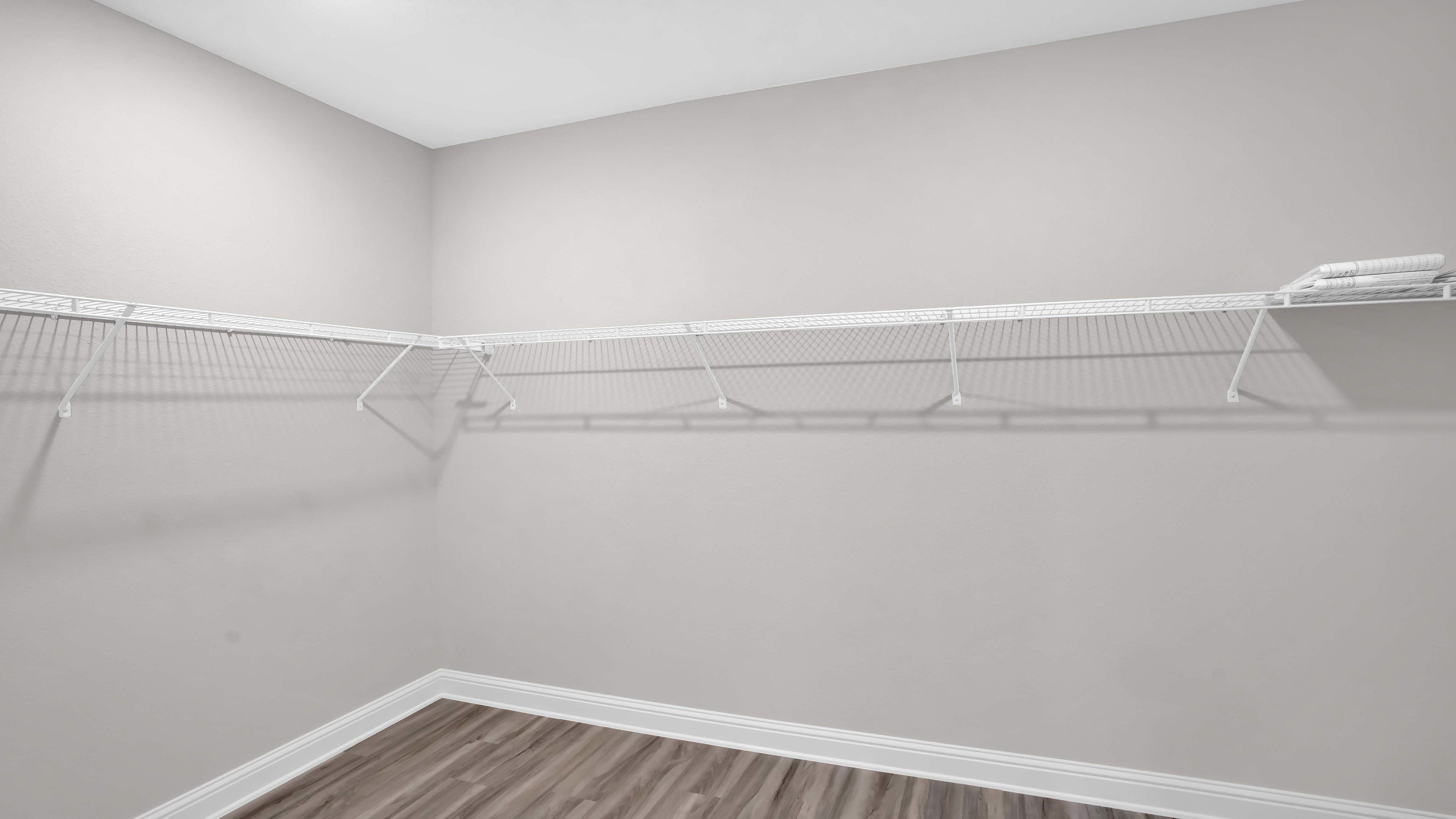 The Jasmine primary walk in closet in Crane Landing.