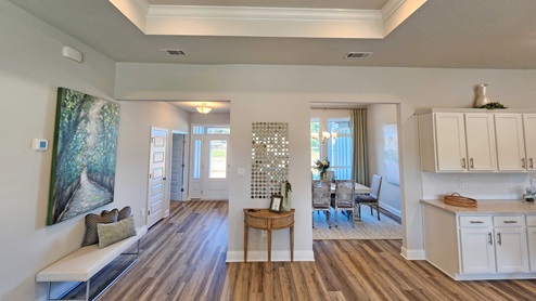Living room area facing into foyer and dining room.