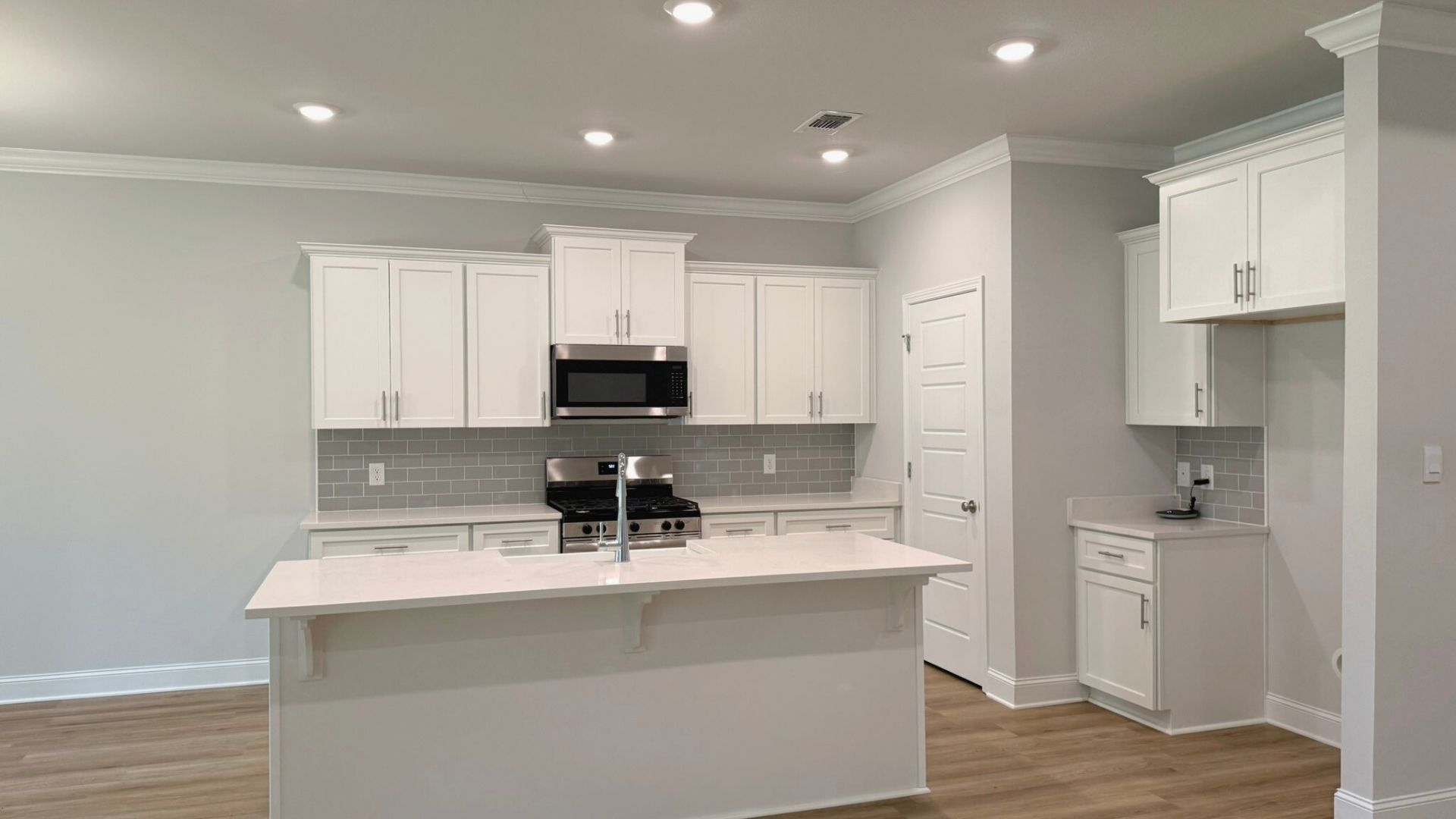 Kitchen with white cabinetry.
