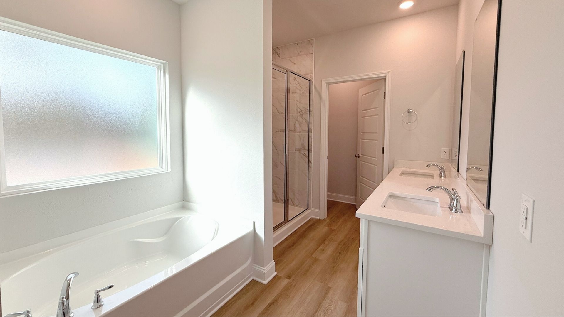 Bathroom with a separate bathtub and walk in shower.