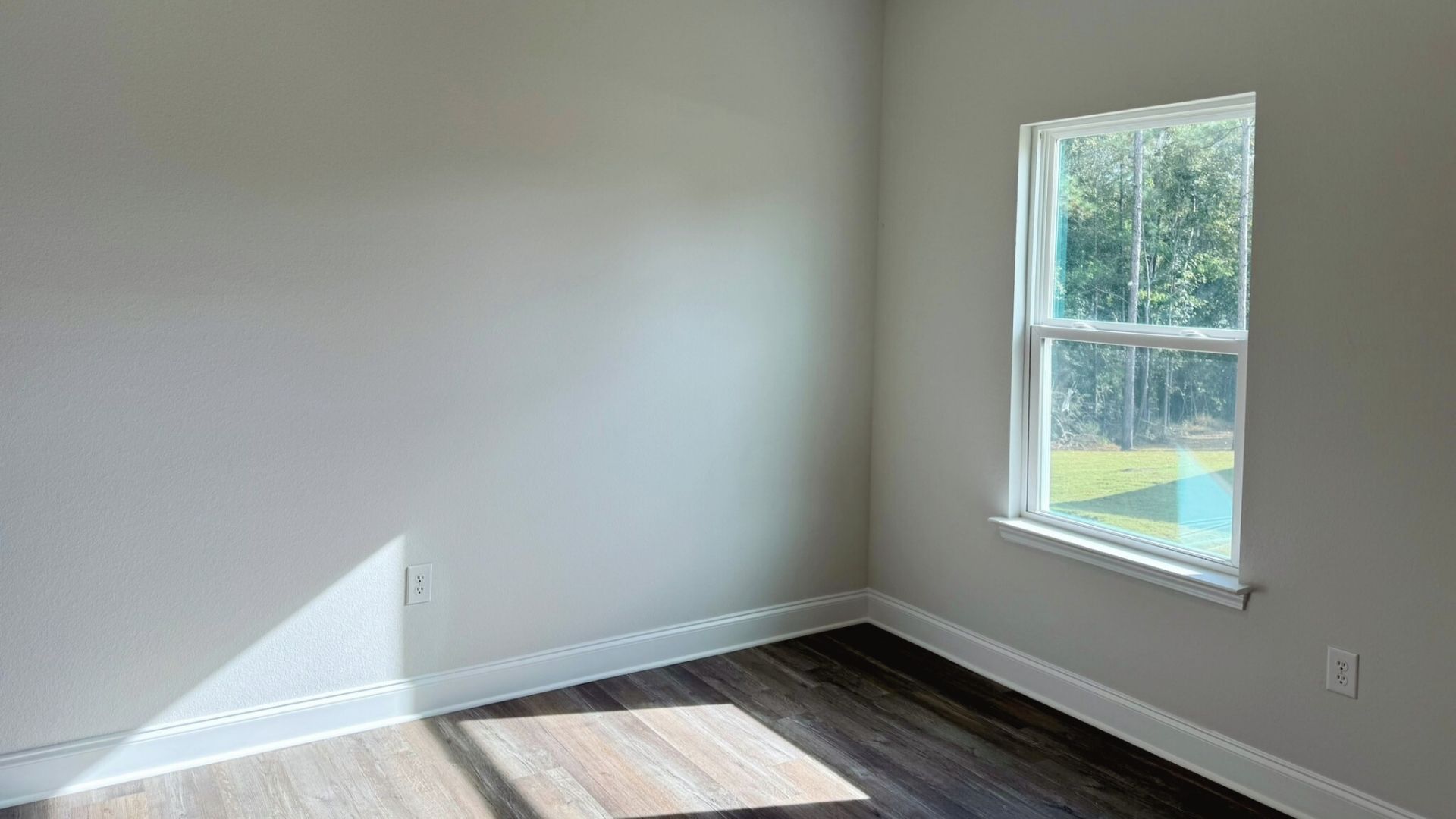 Bedroom with brown flooring.