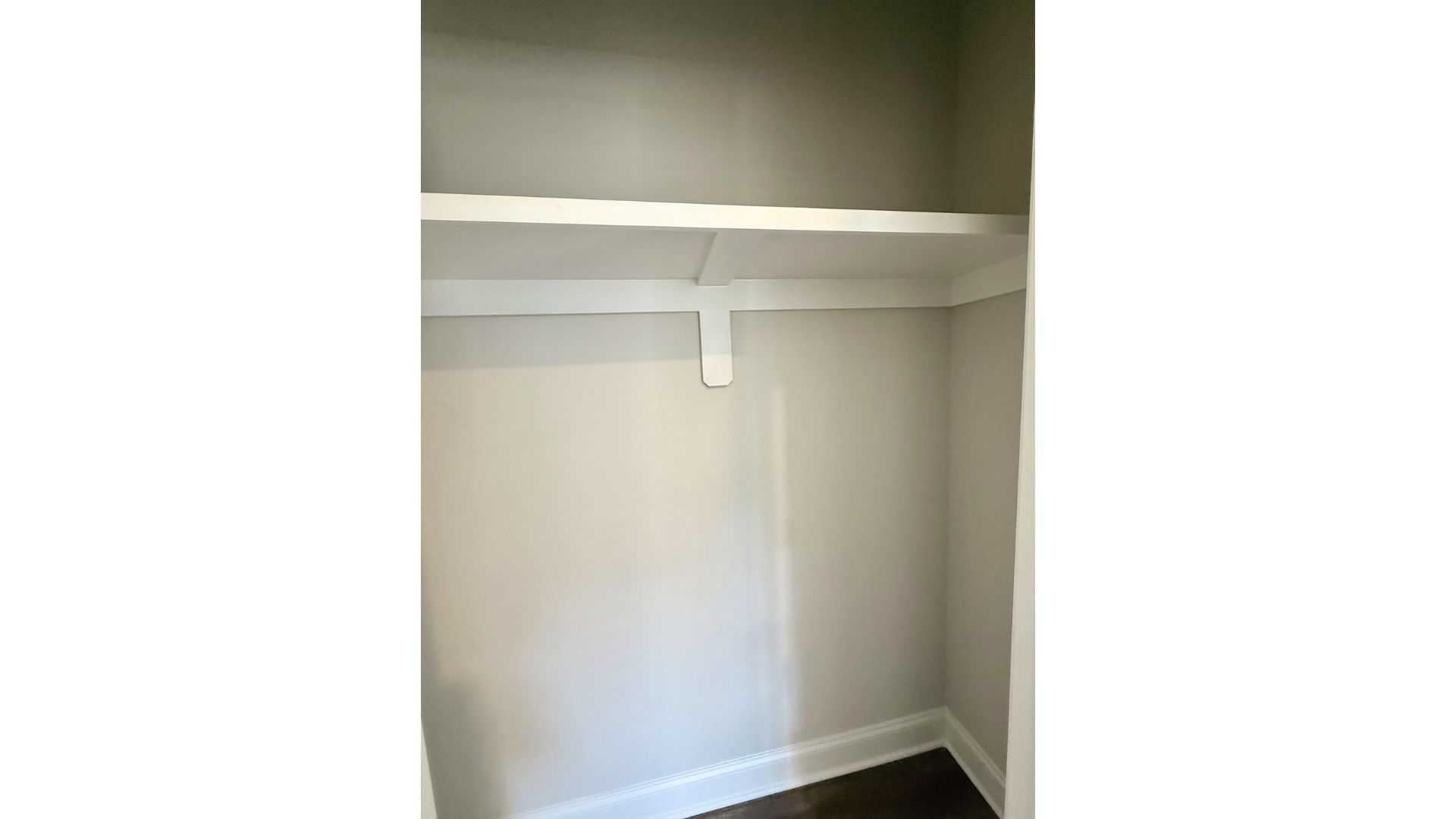 Closet with storage shelf.