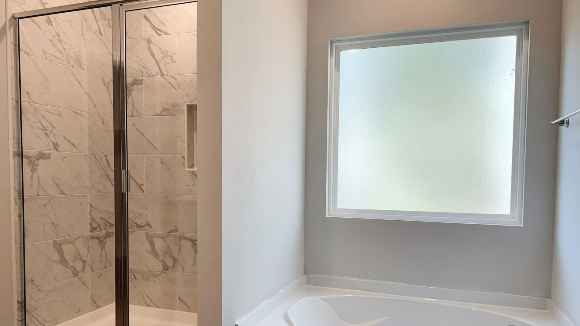 Bathroom with a bathtub and a walk in shower.