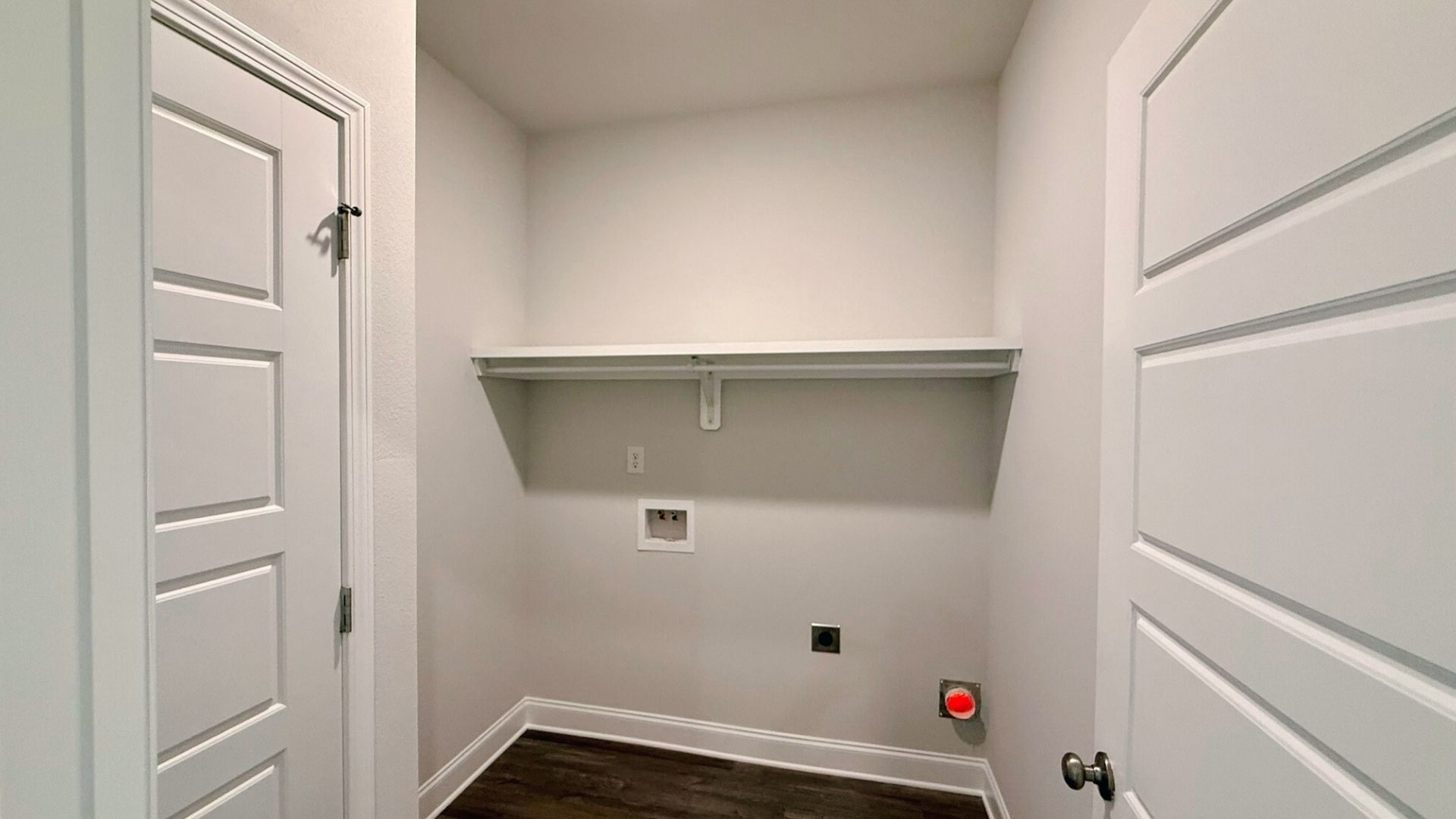 Laundry space with built in shelving.