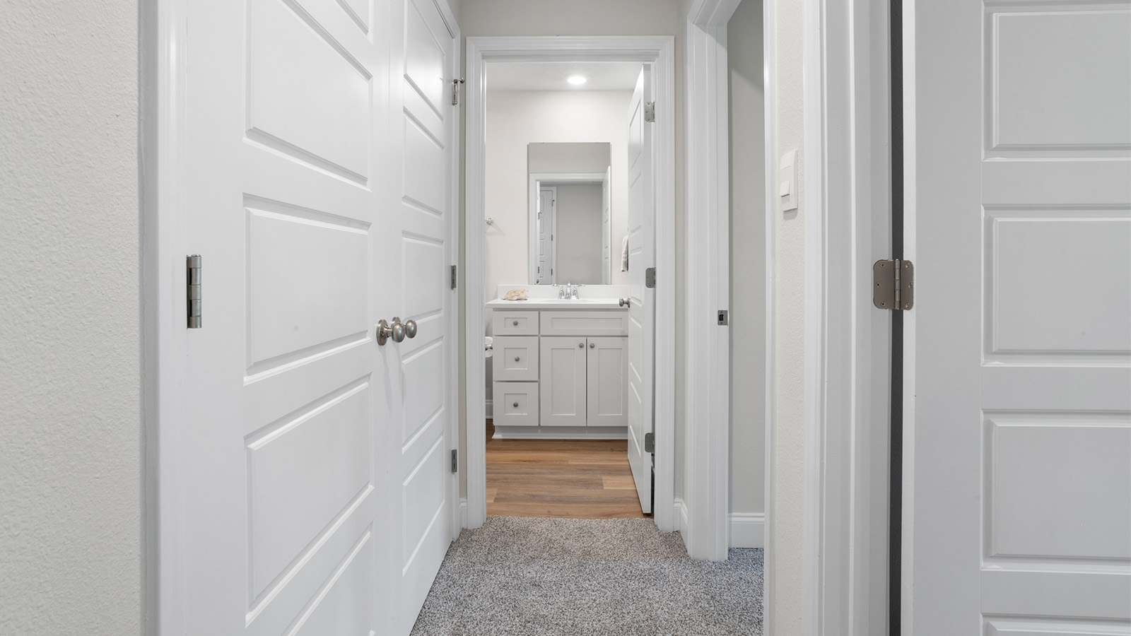 Doorway into the primary bathroom in a new Palm B floorplan in Lost Garden Villas.