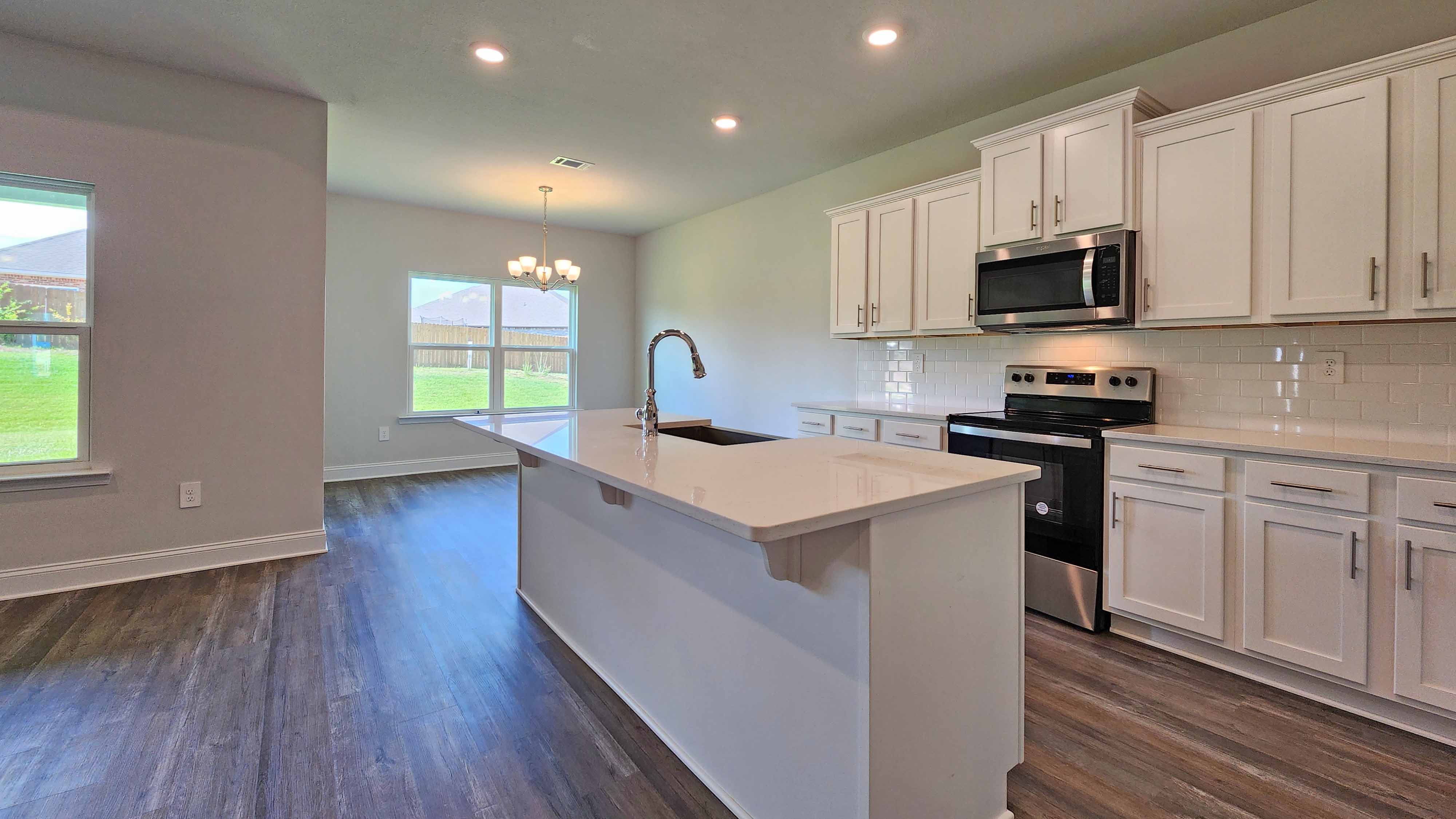 Spacious kitchen with a large island in a DR Horton home in Petal