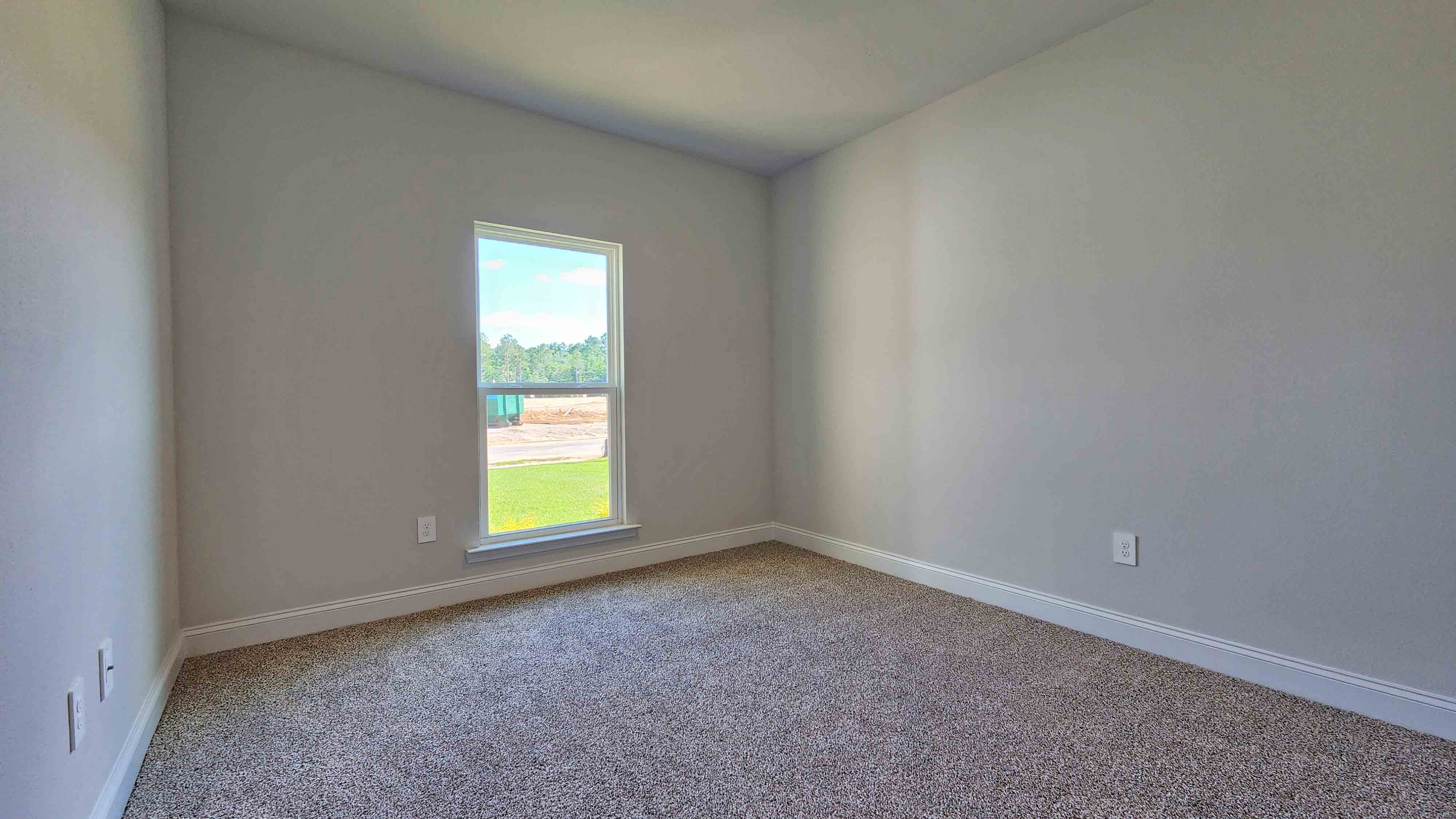 Comfortable guest bedroom with fresh neutral tones in the Holly.