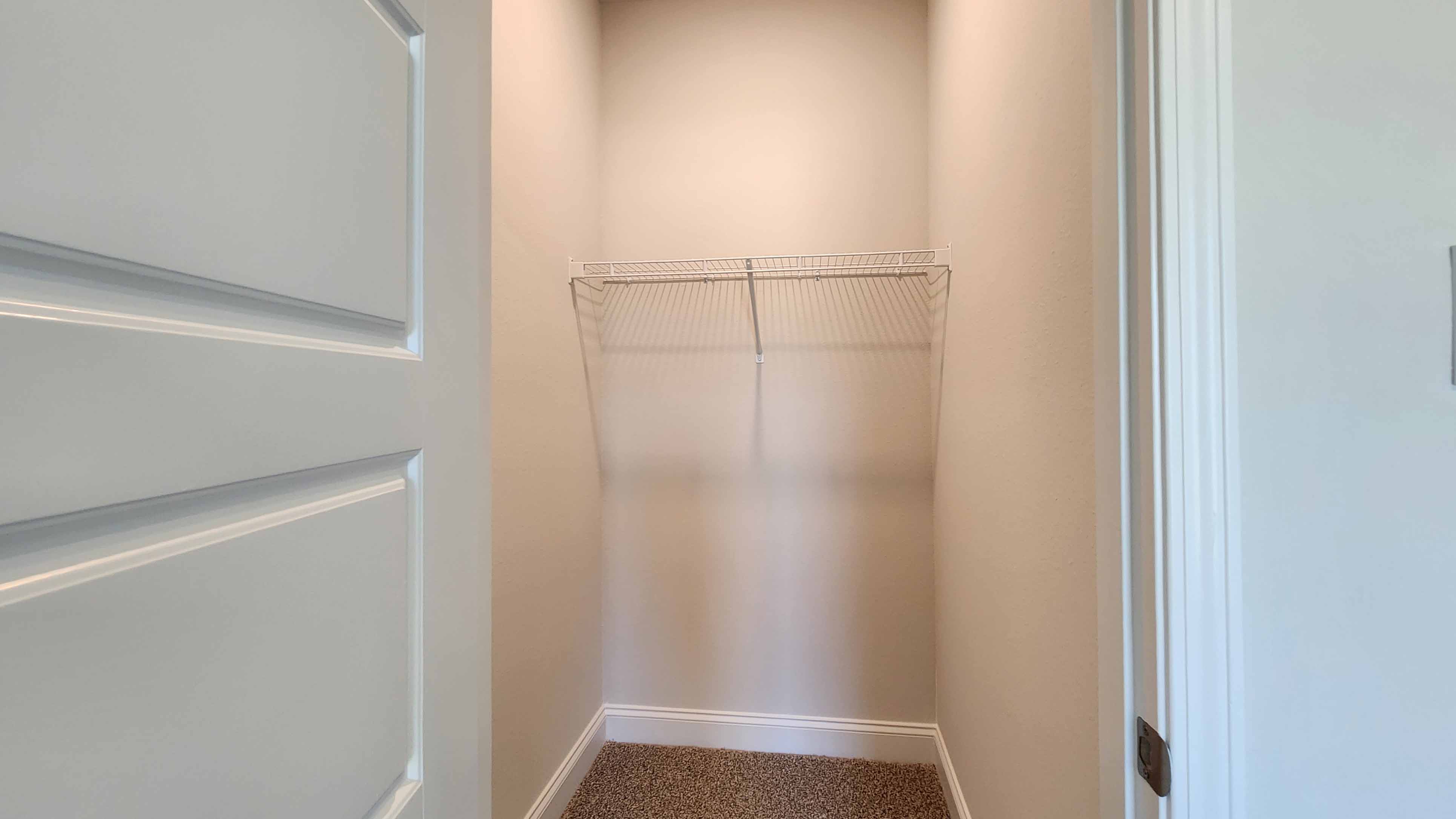 Large guest closet with shelf in the Holly by DR Horton.