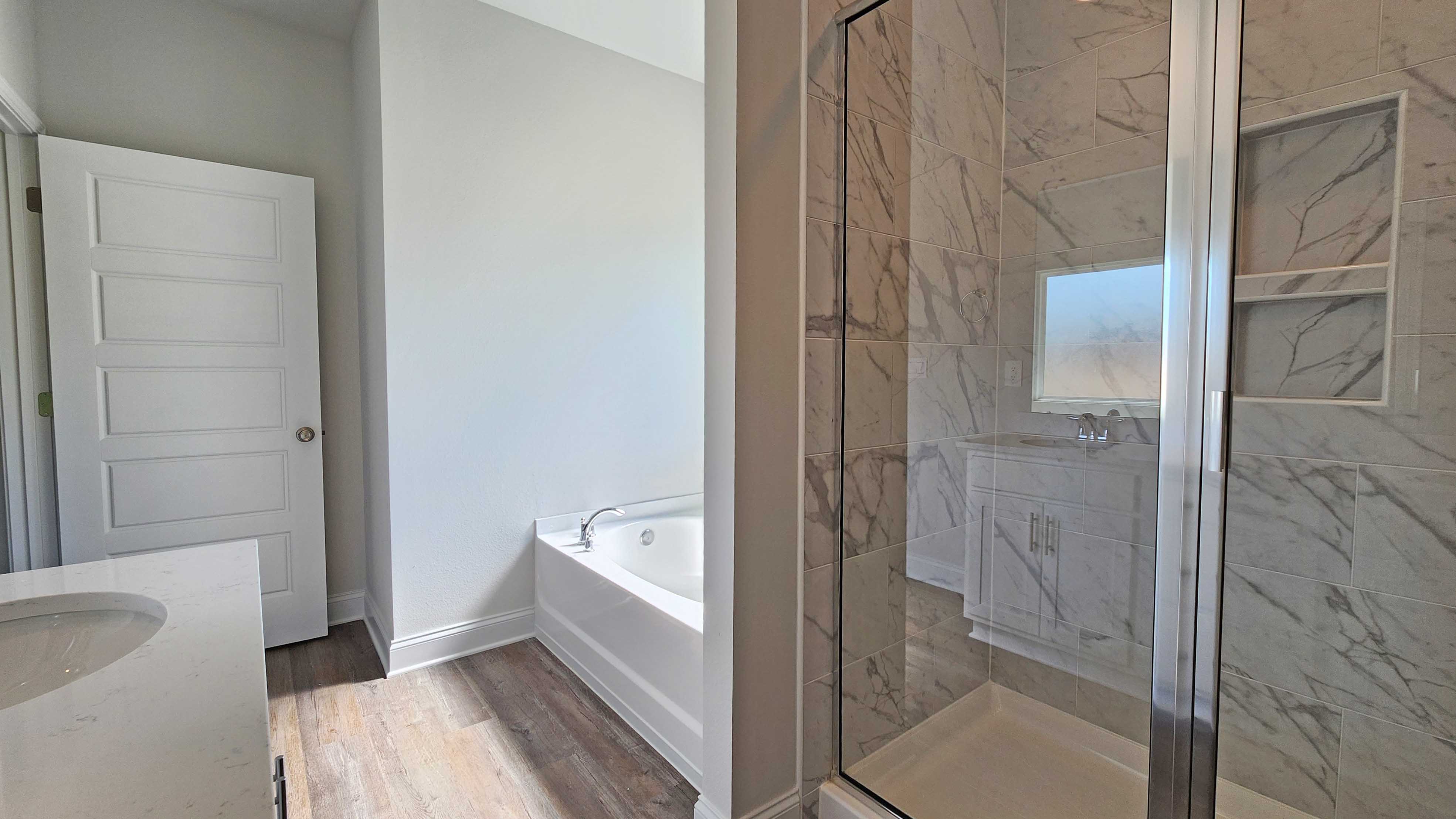 Large walk in shower with soaking garden tub in a DR Horton home in Castlewoods