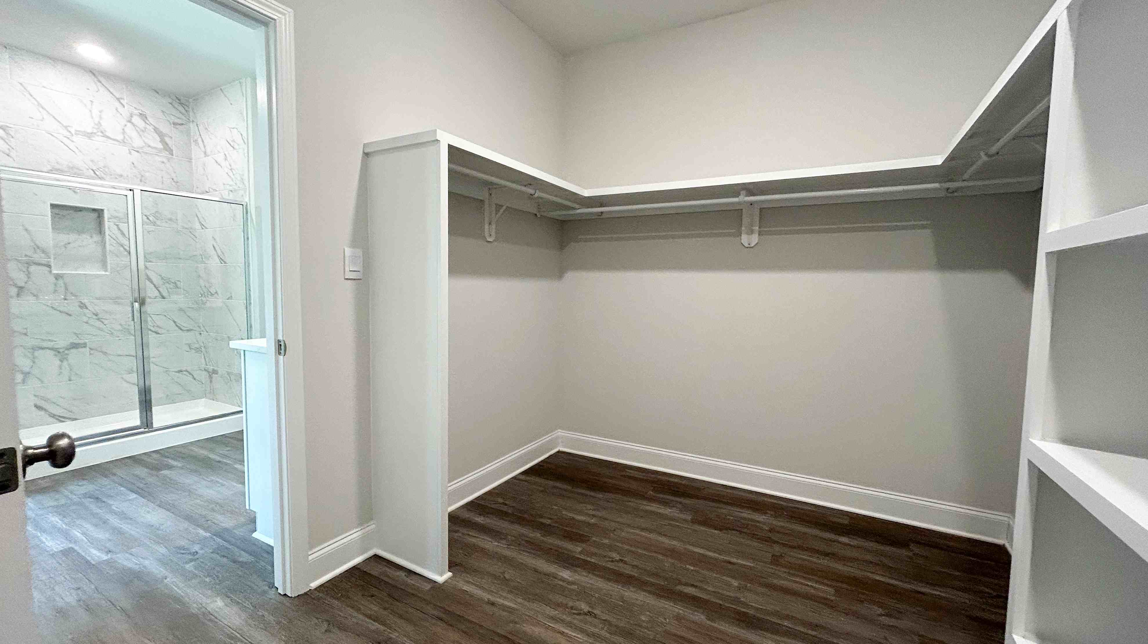 The Jasmine primary walk-in closet at Castlewoods.