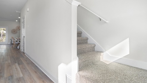 Entrance into the home with naturally lit up staircase