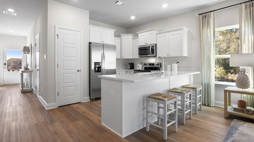Spacious kitchen connected to living and dining area inside the Palm floorplan