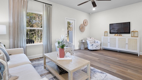 Bright and airy living area connected to back patio inside the Palm