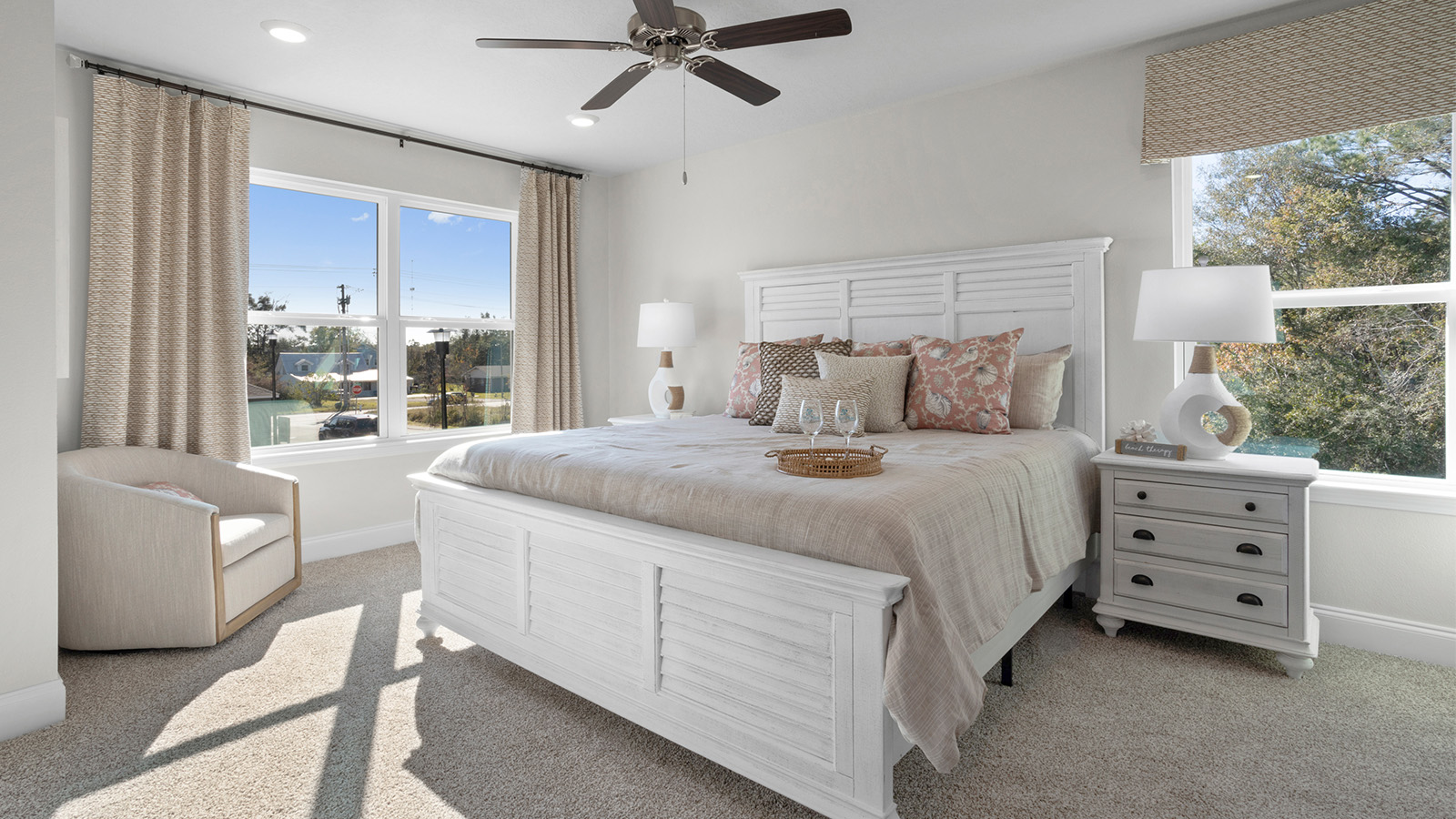 This sun-filled primary bedroom with ceiling fan is located in the Sabal Interior floorplan.