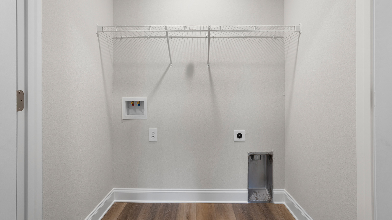 Functional laundry room with shelving for storage in Ocean Springs.