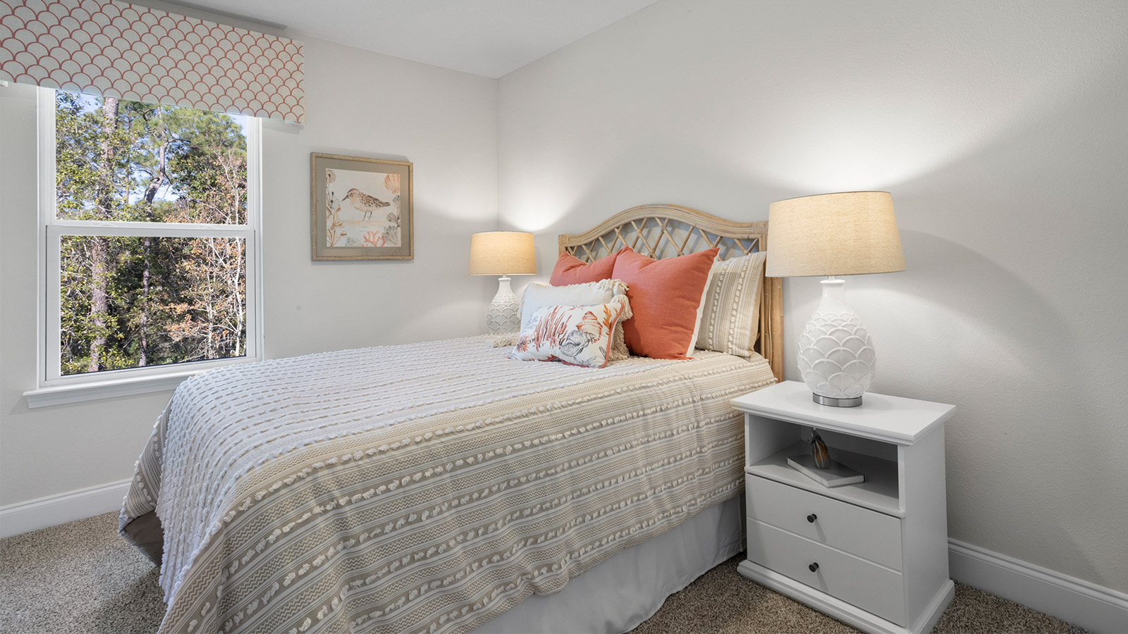 This cozy guest room with lamp and bedding sits inside a new D.R. Horton townhome.