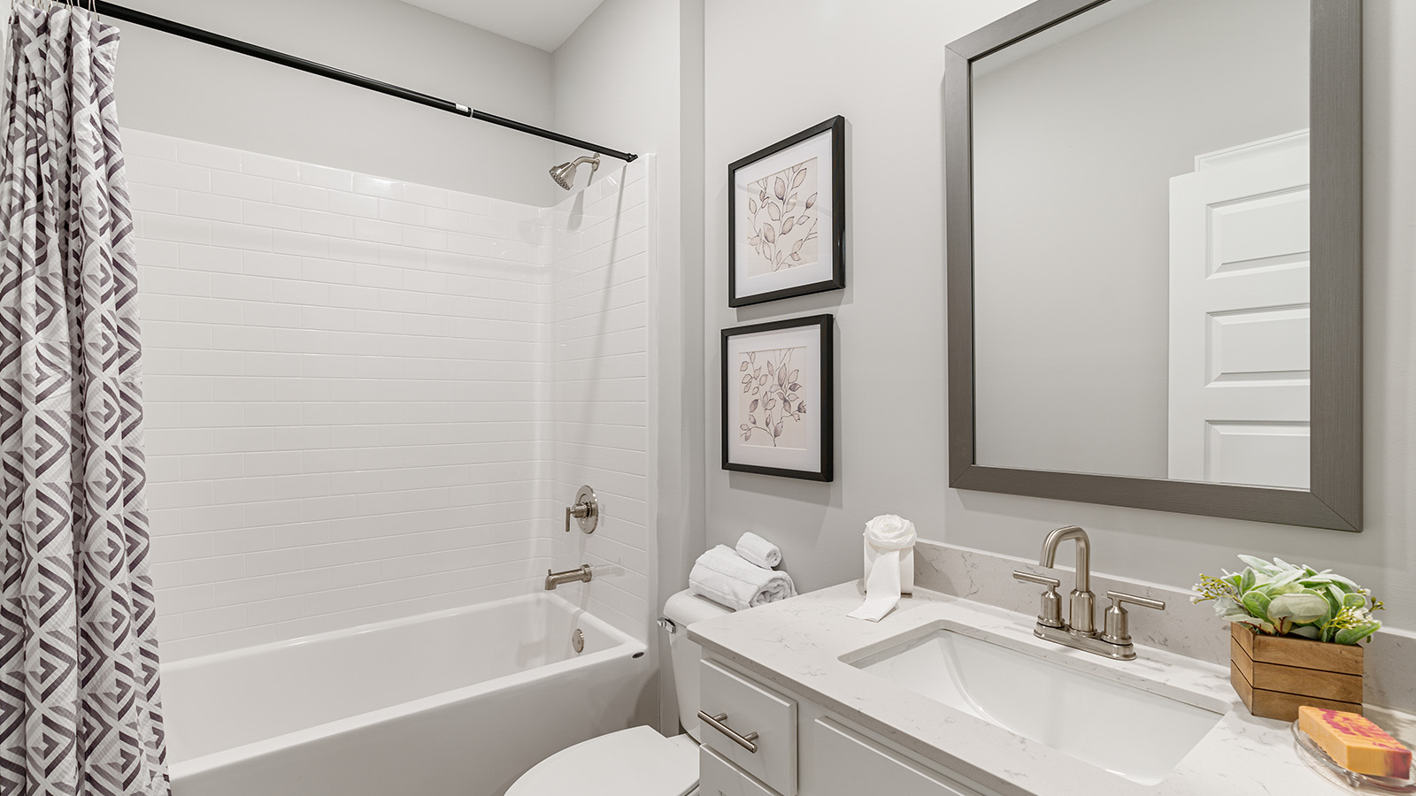 luxury vinyl plan flooring in bathrooms with quartz countertops