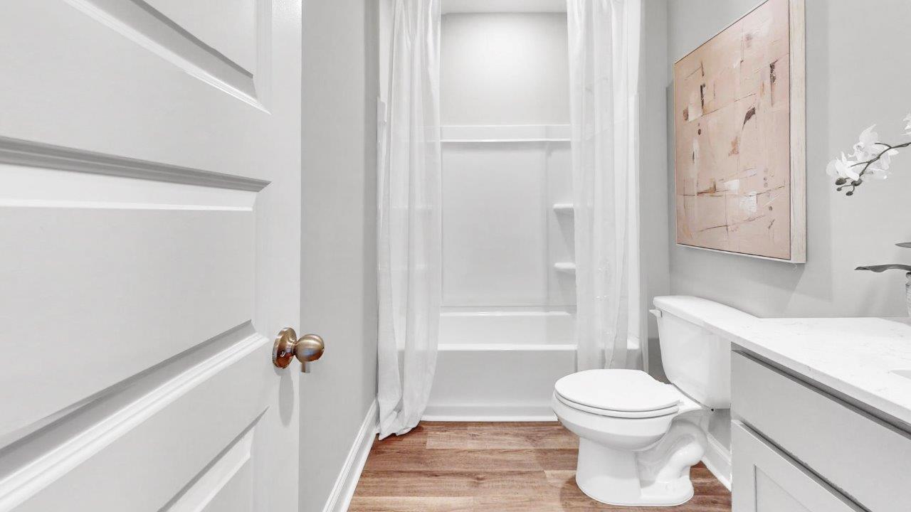 Full bath with tub/shower combo and durable surfaces