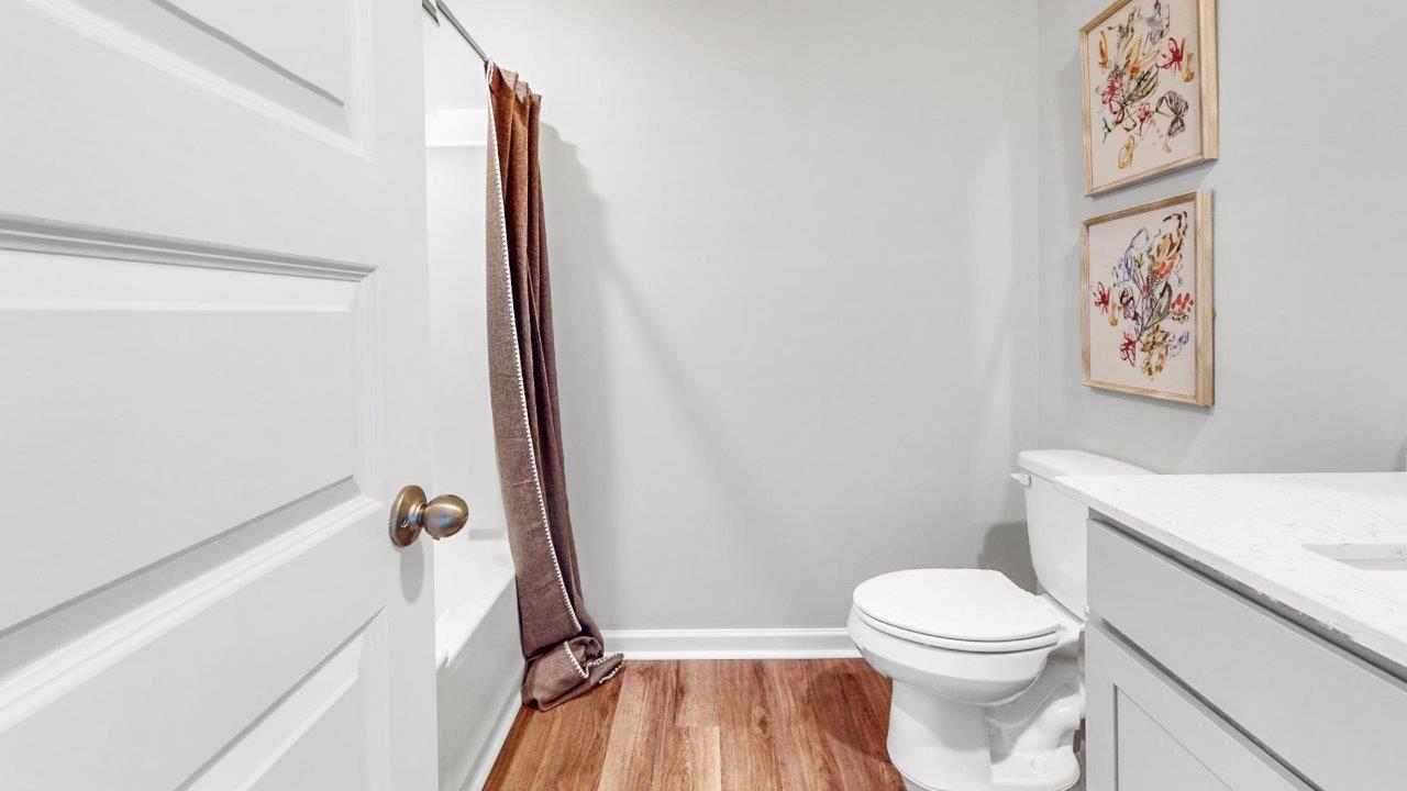 Full bath with tub/shower combo and durable surfaces