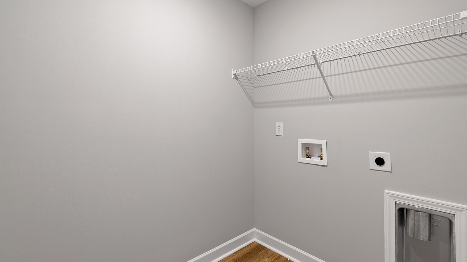 Functional laundry space featuring LVP floors and convenient hookups.