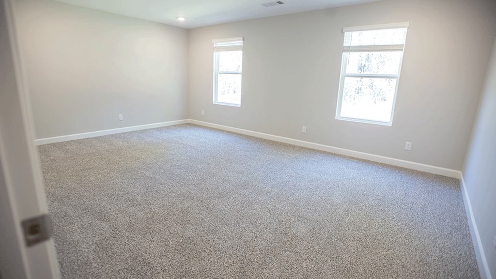 Large primary bedroom designed for privacy and everyday comfort.