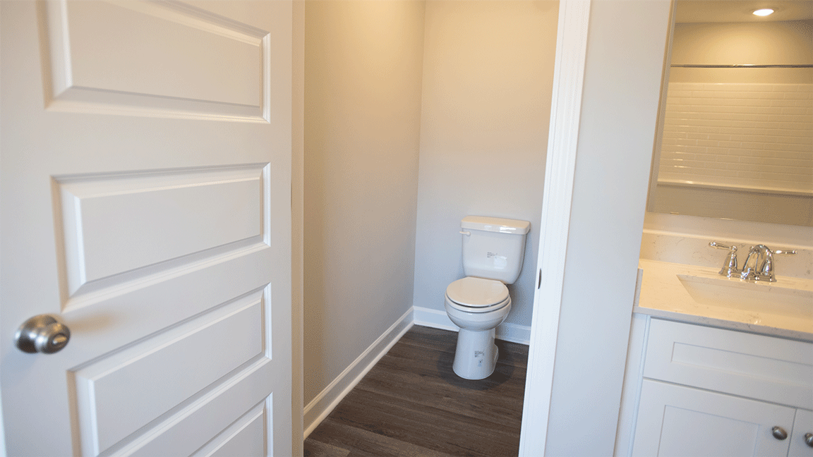 Spacious primary bath with double quartz vanities, separate shower, and garden tub.