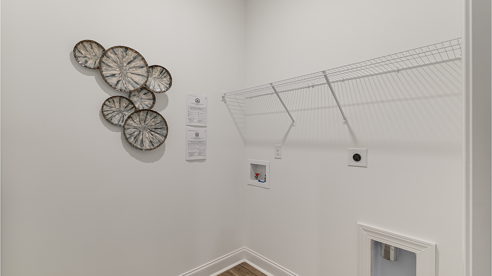 Spacious laundry area with durable flooring and storage options