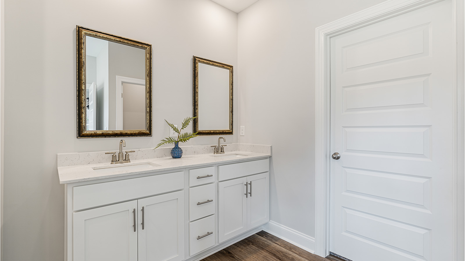 luxury vinyl plan flooring in bathrooms with quartz countertops