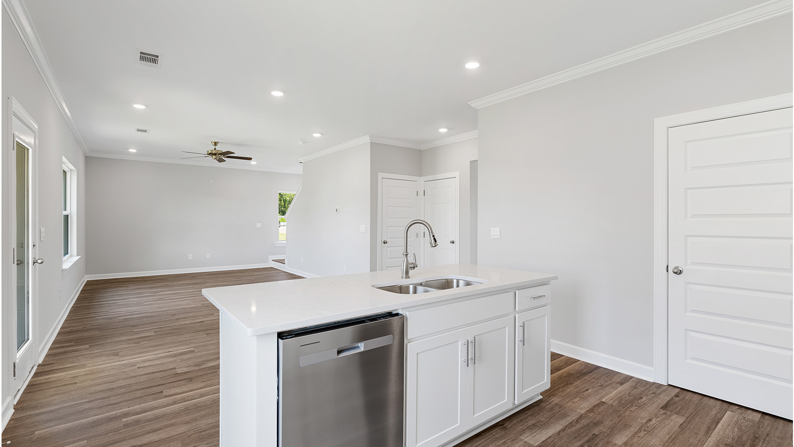 luxury vinyl plank flooring in kitchen with stainless steel appliances and Quartz countertops with soft close cabinets