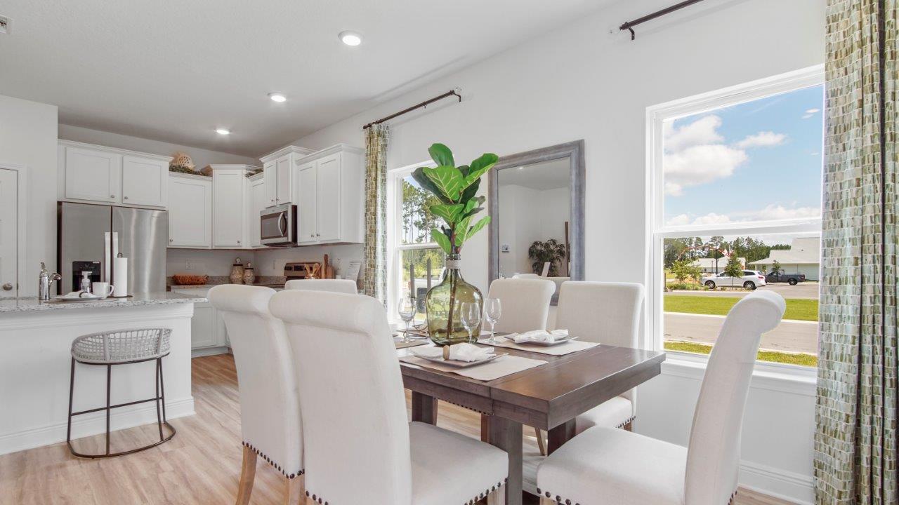Central dining space connecting seamlessly to the kitchen and living room.