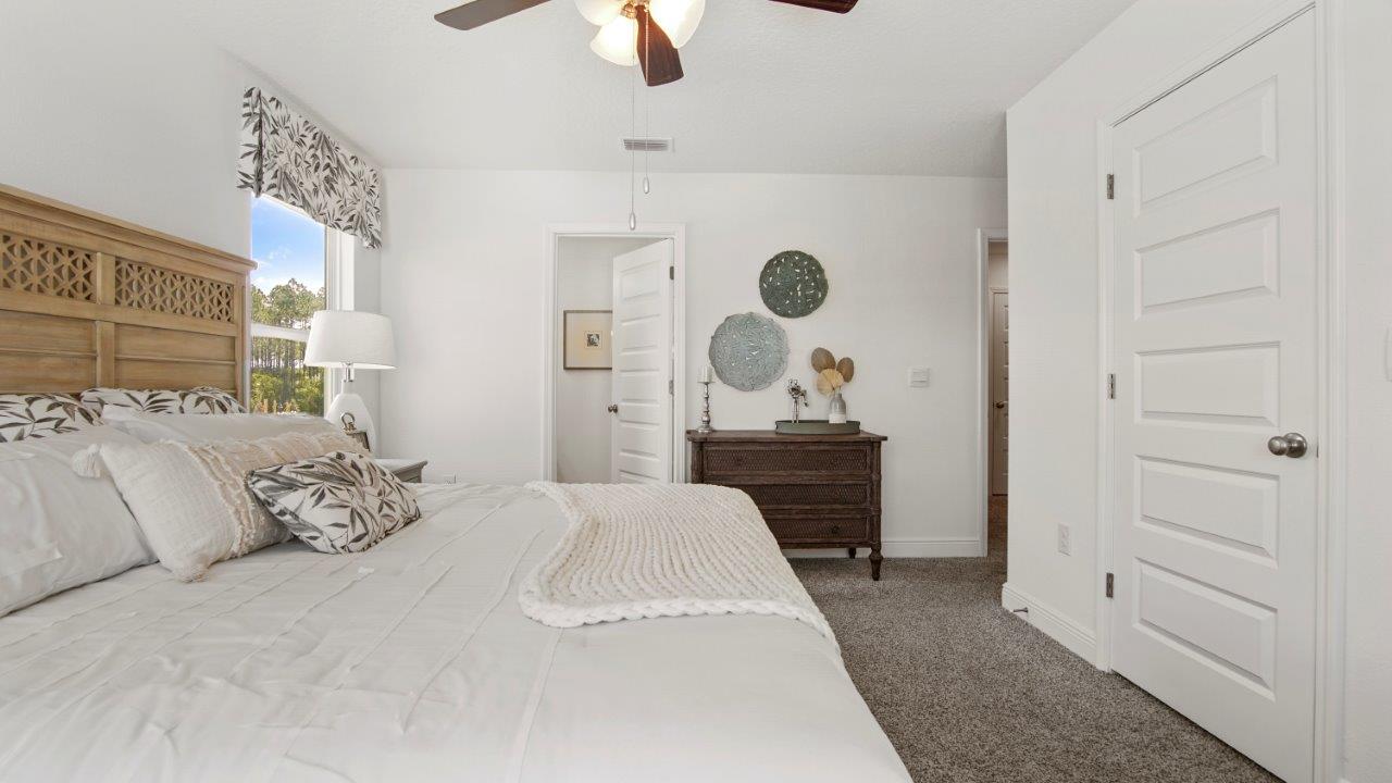 Comfortable primary suite with a quiet atmosphere and cozy carpet flooring.