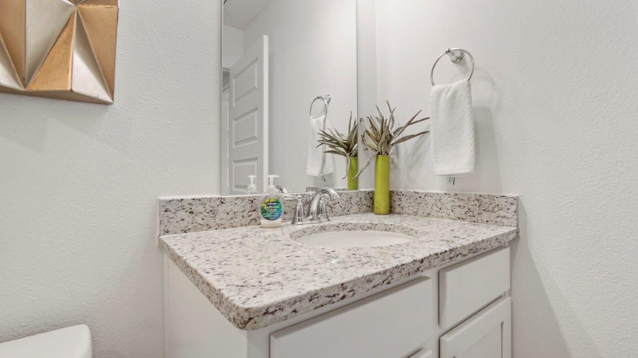 Functional full bath offering a tub/shower combo and easy to maintain surfaces.