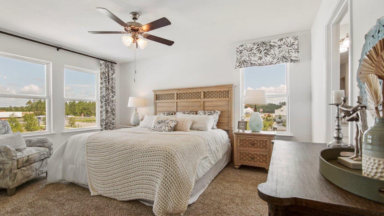 Relaxing primary retreat featuring plush carpet and generous room for furniture.