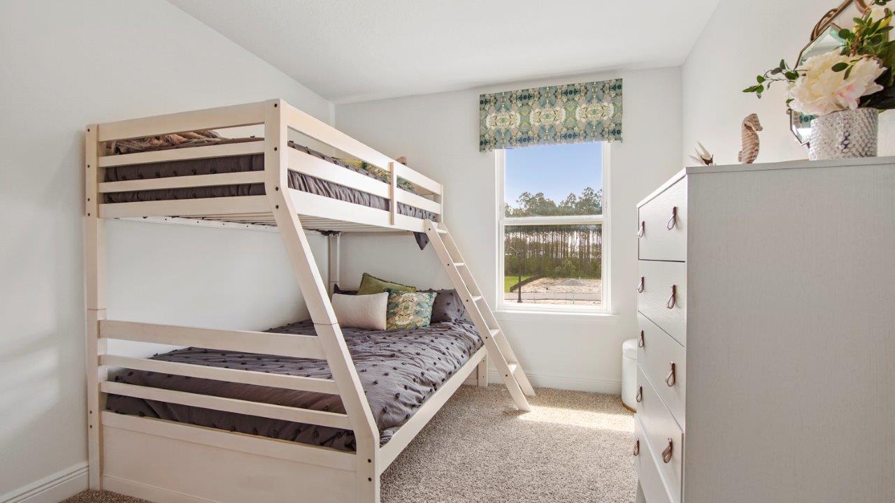 Comfortable guest bedroom with soft carpet and a spacious closet.