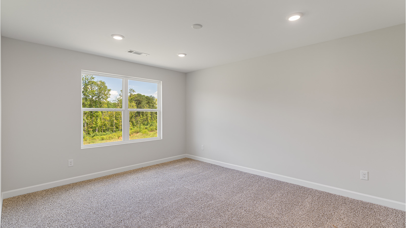 Relaxing primary retreat featuring plush carpet and generous room for furniture.