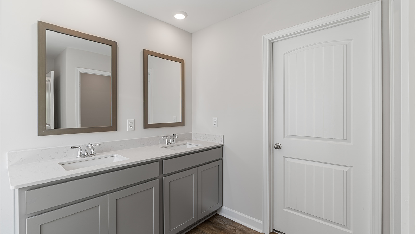 Luxury primary suite featuring a walk in closet, dual vanities, and a separate tub and shower.